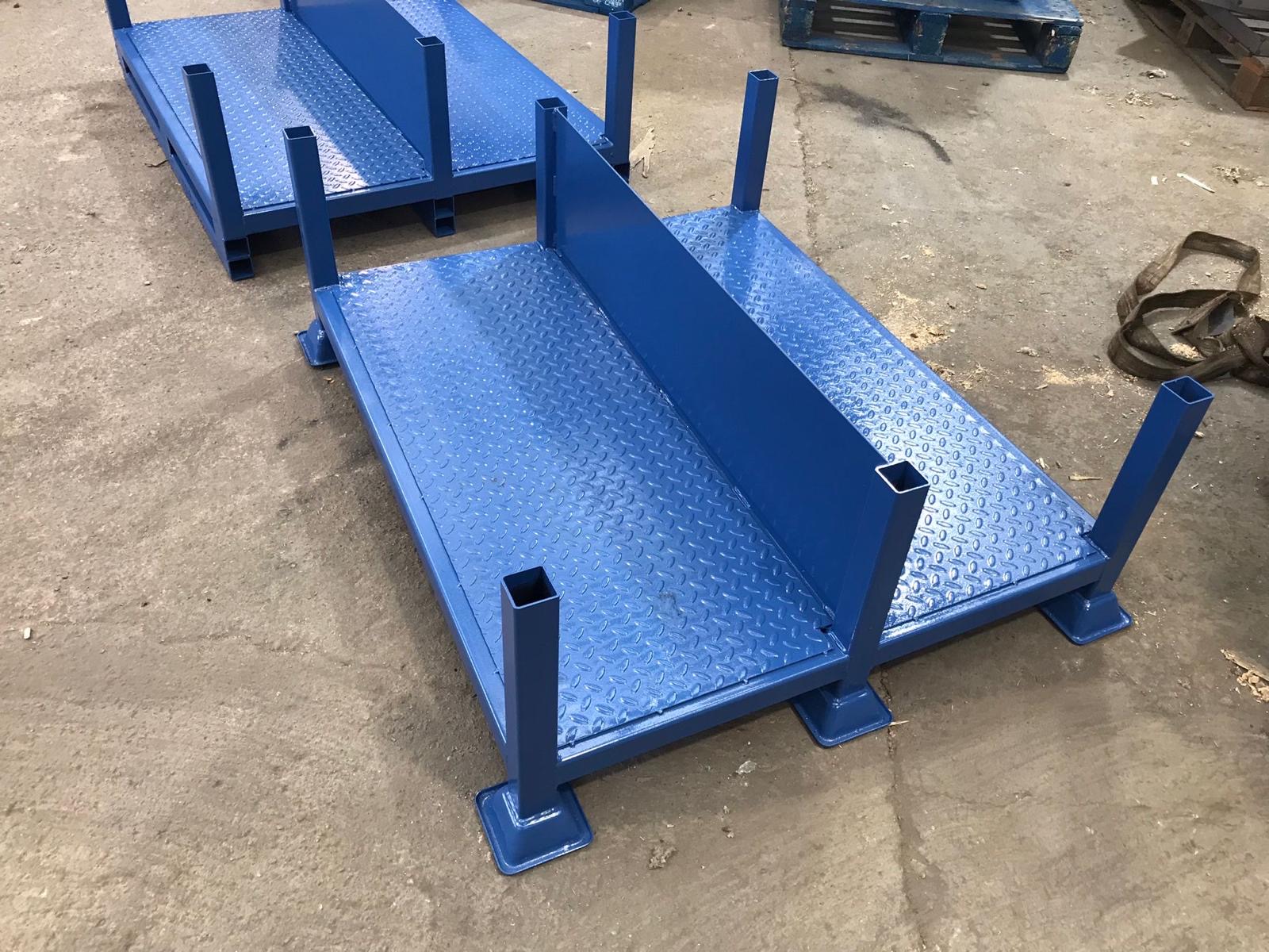 Blue painted steel stillage with vertical posts outdoors